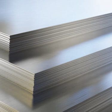 Steel or aluminum sheets in warehouse, rolled metal product.